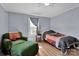 Charming bedroom with a comfy green armchair, matching bedspread, and wood-look flooring at 1339 Hill St, Albemarle, NC 28001