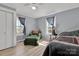 Charming bedroom with a comfy green armchair, matching bedspread, and wood-look flooring at 1339 Hill St, Albemarle, NC 28001