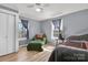 Charming bedroom with a comfy green armchair, matching bedspread, and wood-look flooring at 1339 Hill St, Albemarle, NC 28001