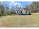 A view of the house, featuring a quaint front porch and surrounded by a lawn at 1339 Hill St, Albemarle, NC 28001