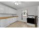 Kitchen with white cabinets, subway tile backsplash, and butcher block countertop at 1339 Hill St, Albemarle, NC 28001