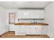 A functional kitchen with a butcher block countertop, white cabinets, and subway tile backsplash at 1339 Hill St, Albemarle, NC 28001