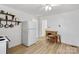 Kitchen with white appliances, wood-look floors, and decorative shelving at 1339 Hill St, Albemarle, NC 28001