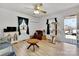 Bright living room with refinished floors, a ceiling fan, and a cat tree at 1339 Hill St, Albemarle, NC 28001