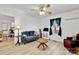 Bright living room with a ceiling fan, refinished floors, and a large window at 1339 Hill St, Albemarle, NC 28001