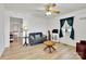 Cozy living room with hardwood floors, ceiling fan, and comfortable furnishings at 1339 Hill St, Albemarle, NC 28001