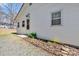 The exterior featuring white siding, a white door and windows, complemented by decorative landscaping at 1339 Hill St, Albemarle, NC 28001