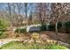 Landscaped backyard featuring a stone walkway with greenery and a privacy fence at 1347 Lightwood Dr, Matthews, NC 28105