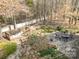 Aerial view of backyard with a wooden deck, brick patio, chairs, fire pit, and water feature at 1347 Lightwood Dr, Matthews, NC 28105