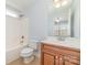 Bathroom featuring a single sink vanity with framed mirror and a shower-tub combo at 1347 Lightwood Dr, Matthews, NC 28105