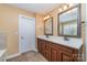 Bathroom showcasing a double sink vanity with a wood cabinet and framed mirrors with decorative lighting at 1347 Lightwood Dr, Matthews, NC 28105