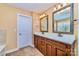 Bathroom features a double sink with wooden cabinetry and decorative framed mirrors at 1347 Lightwood Dr, Matthews, NC 28105