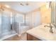 Bright bathroom with a shower, soaking tub, and a vanity with double sinks and decorative mirrors at 1347 Lightwood Dr, Matthews, NC 28105