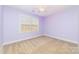 Bedroom with neutral carpet, ceiling fan, and light purple walls at 1347 Lightwood Dr, Matthews, NC 28105