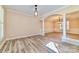 Spacious dining room showcasing light wood flooring, decorative columns and wainscoting at 1347 Lightwood Dr, Matthews, NC 28105