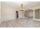 Bright dining room featuring elegant lighting, wainscoting, and an open floor plan at 1347 Lightwood Dr, Matthews, NC 28105