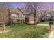 Charming two-story brick home featuring a well-manicured lawn and attached two-car garage at 1347 Lightwood Dr, Matthews, NC 28105