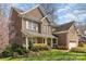 Beautiful brick home with a welcoming front porch and lush landscaping creating great curb appeal at 1347 Lightwood Dr, Matthews, NC 28105