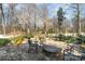 Backyard patio and fire pit area with mature trees, professional landscaping, and a water feature at 1347 Lightwood Dr, Matthews, NC 28105