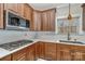 Kitchen with wood cabinets, stone countertops, and stainless-steel oven and sink at 1347 Lightwood Dr, Matthews, NC 28105