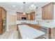 Kitchen featuring wooden cabinets, stainless steel appliances, stone countertops, and a kitchen island at 1347 Lightwood Dr, Matthews, NC 28105