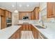 Kitchen featuring wooden cabinets, stainless steel appliances, stone countertops, and an island at 1347 Lightwood Dr, Matthews, NC 28105