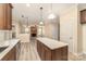 Open concept kitchen with island offering a view of the living room and fireplace at 1347 Lightwood Dr, Matthews, NC 28105