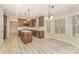 Well-lit kitchen boasting stainless steel appliances, island, and wood cabinets at 1347 Lightwood Dr, Matthews, NC 28105