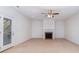 Spacious living room with fireplace, neutral carpet, and door leading to a deck at 1347 Lightwood Dr, Matthews, NC 28105