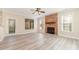 Cozy living room featuring a stone fireplace, ceiling fan, and natural light at 1347 Lightwood Dr, Matthews, NC 28105