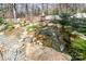 Backyard stream and pond with lush landscaping and rock details at 1347 Lightwood Dr, Matthews, NC 28105