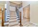 Grand staircase with wood and iron railings, complemented by hardwood floors and neutral walls at 1347 Lightwood Dr, Matthews, NC 28105