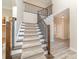 Carpeted staircase with decorative iron railing and wood trim at 1347 Lightwood Dr, Matthews, NC 28105