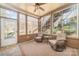 Cozy sunroom with ceiling fan, comfortable seating, and lots of windows offering plenty of natural light at 1347 Lightwood Dr, Matthews, NC 28105