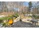 Backyard water feature with professional landscaping, mature trees, and stone patio at 1347 Lightwood Dr, Matthews, NC 28105