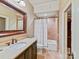 Bathroom featuring a vanity, tiled shower, and well-placed lighting at 1355 Wyndmere Hills Ln, Matthews, NC 28105