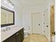 Well-lit bathroom showcasing a vanity with a dark wood cabinet and neutral countertops at 1355 Wyndmere Hills Ln, Matthews, NC 28105