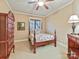 Cozy bedroom featuring a four-poster bed, decorative art, and dark wood furnishings at 1355 Wyndmere Hills Ln, Matthews, NC 28105