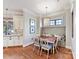 Dining area with bench seating, pendant lighting, view to the kitchen and stainless appliances at 1355 Wyndmere Hills Ln, Matthews, NC 28105