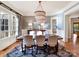 Elegant dining room features a modern chandelier, hardwood floors and large windows at 1355 Wyndmere Hills Ln, Matthews, NC 28105