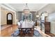 Dining room featuring hardwood floors, large windows, a buffet cabinet, and a modern chandelier at 1355 Wyndmere Hills Ln, Matthews, NC 28105