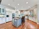 Bright kitchen featuring stainless appliances, custom cabinets, kitchen island and hardwood floors at 1355 Wyndmere Hills Ln, Matthews, NC 28105