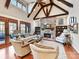 Cozy living room with a stone fireplace, vaulted ceilings with wooden beams and lots of natural light at 1355 Wyndmere Hills Ln, Matthews, NC 28105