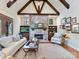 Comfortable living room featuring a stone fireplace, hardwood floors, and built-in shelves at 1355 Wyndmere Hills Ln, Matthews, NC 28105