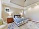 Comfortable main bedroom featuring a trey ceiling, carpet, and decoratively patterned bedding and area rug at 1355 Wyndmere Hills Ln, Matthews, NC 28105