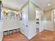 Mud room area with bench, storage, wood floors and bead board at 1355 Wyndmere Hills Ln, Matthews, NC 28105