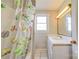 Cozy bathroom features a tub with shower and a single sink vanity with neutral paint at 1414 S Post Rd, Shelby, NC 28152