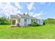 This charming single-story home has a covered side porch and a well-maintained lawn at 1414 S Post Rd, Shelby, NC 28152