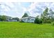 This angle shows the home's exterior and the green space surrounding the property at 1414 S Post Rd, Shelby, NC 28152