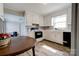 Bright kitchen featuring white cabinets, and a sink, with wood-look floors at 1414 S Post Rd, Shelby, NC 28152